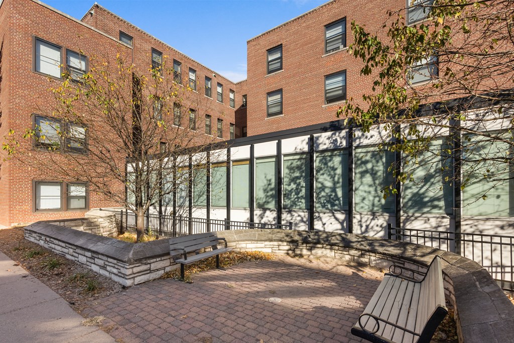 a bench in front of a building with a glass facade