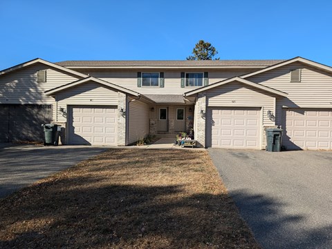 a house with two garage doors and a driveway