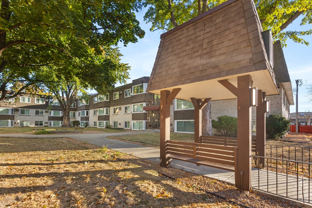 a building with a porch with a bench in front of it