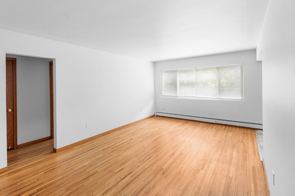 A room with wooden floors and a window.