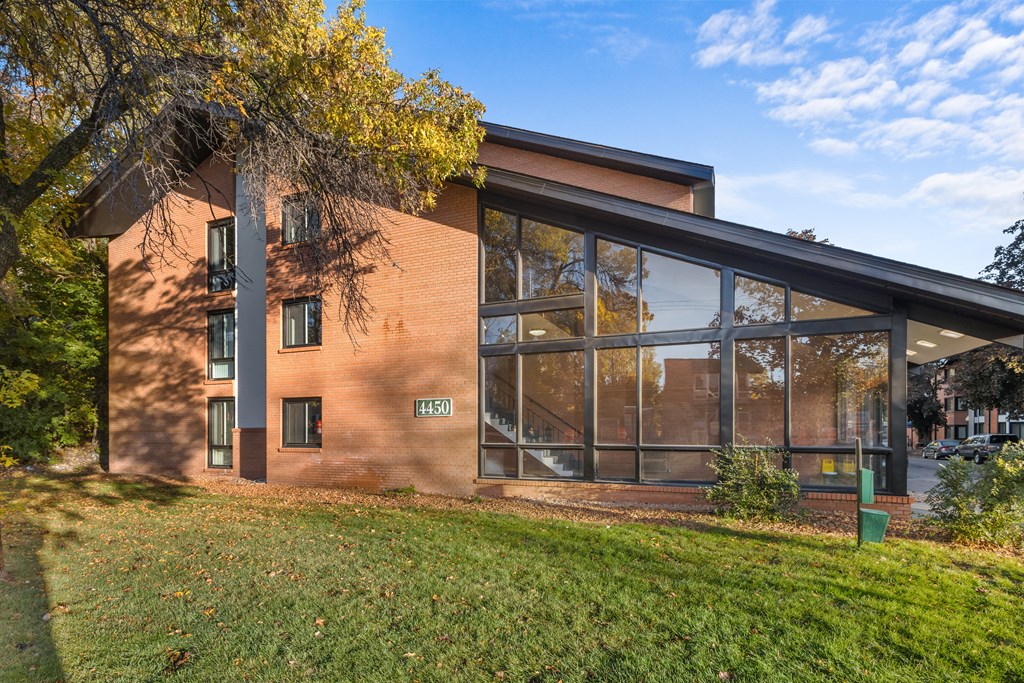 the exterior of a brick building with large glass windows