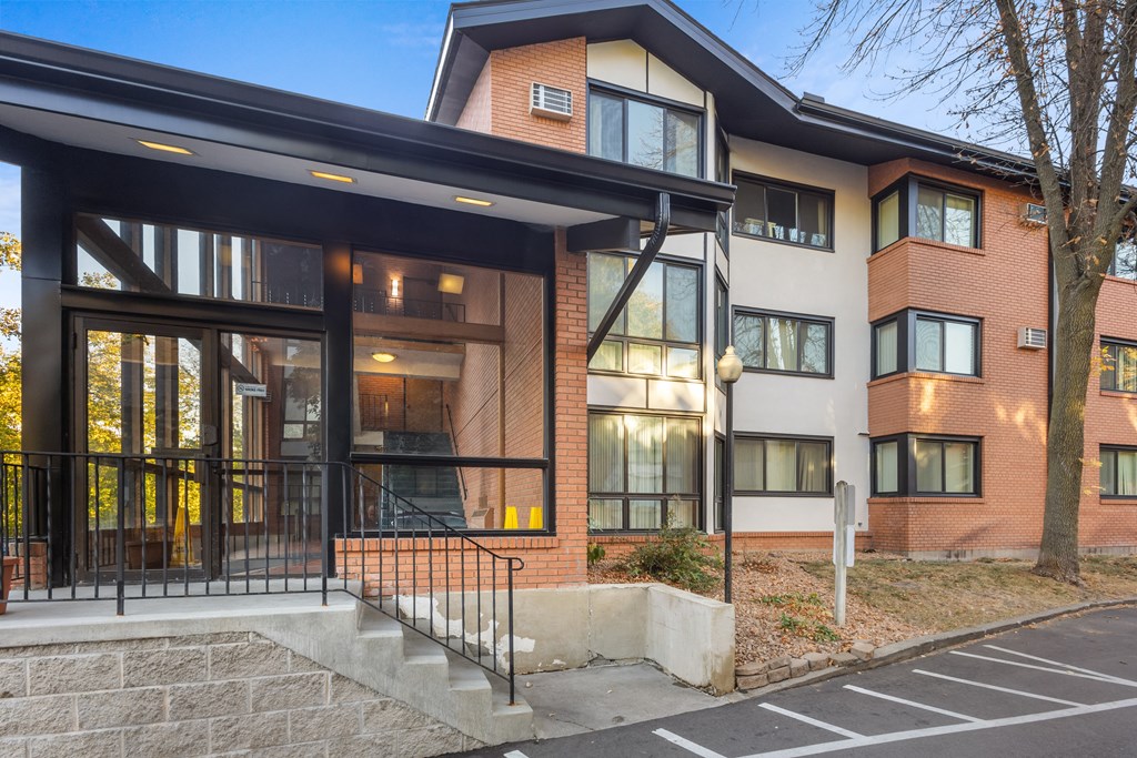 the facade of a new apartment building with glass doors and a staircase
