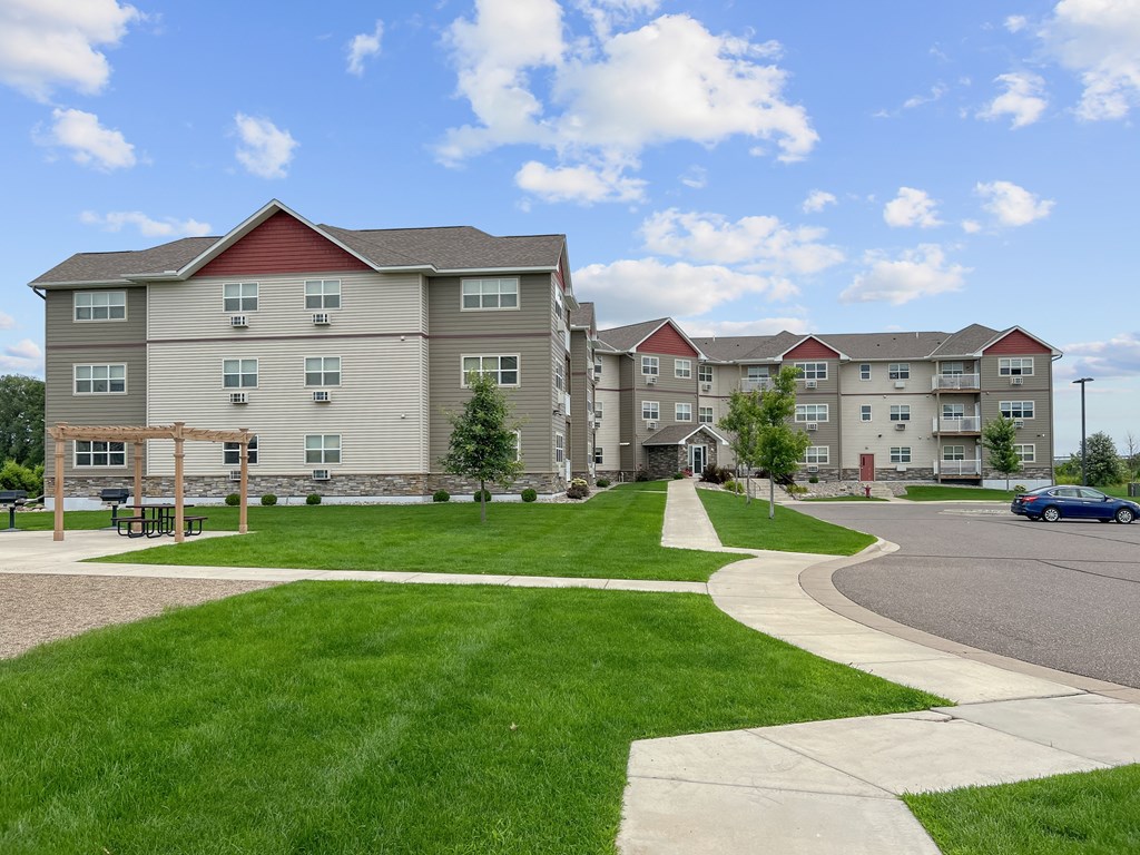 Apartment complex with a green lawn in front.