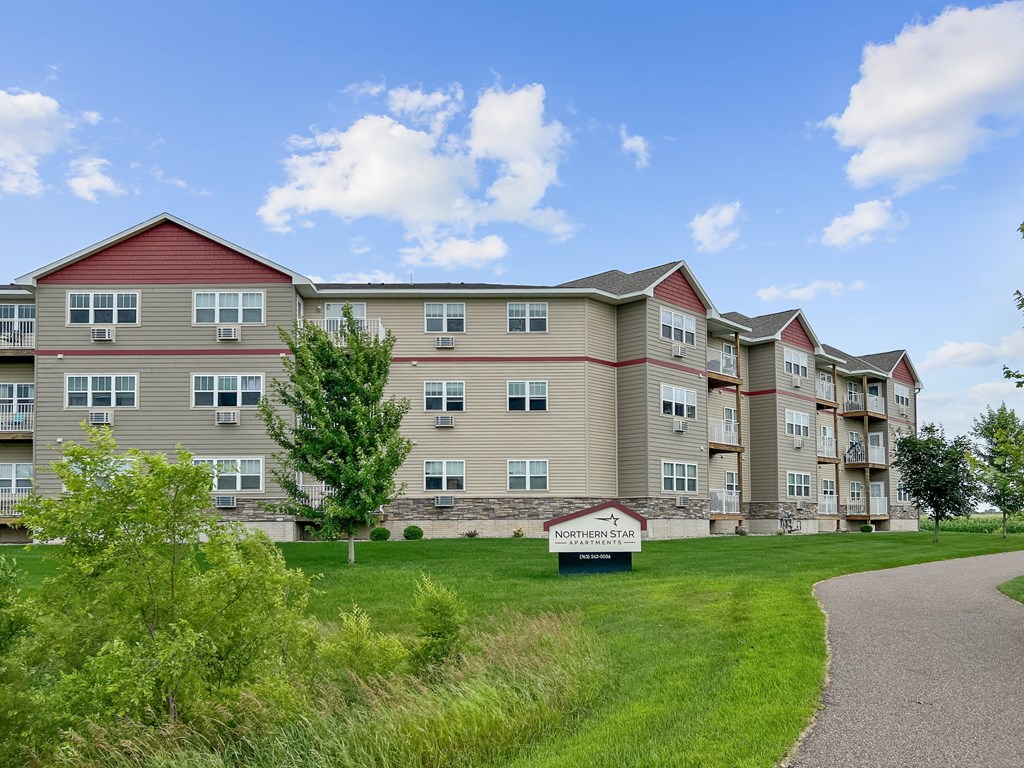 A building with a sign that says "Apartment Homes" in front of it.