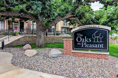 the oaks on pleasant sign in front of trees and rocks