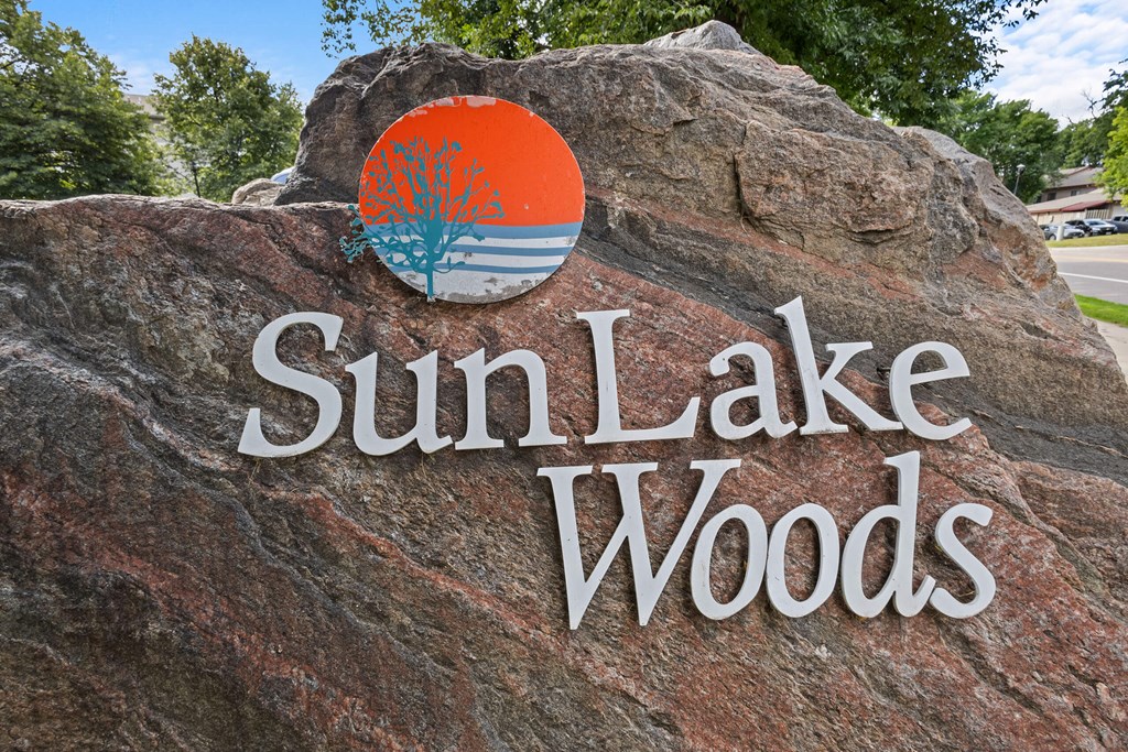 a rock with the sun lake woods logo on it