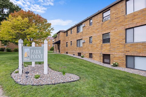 a park point sign in front of a brick building