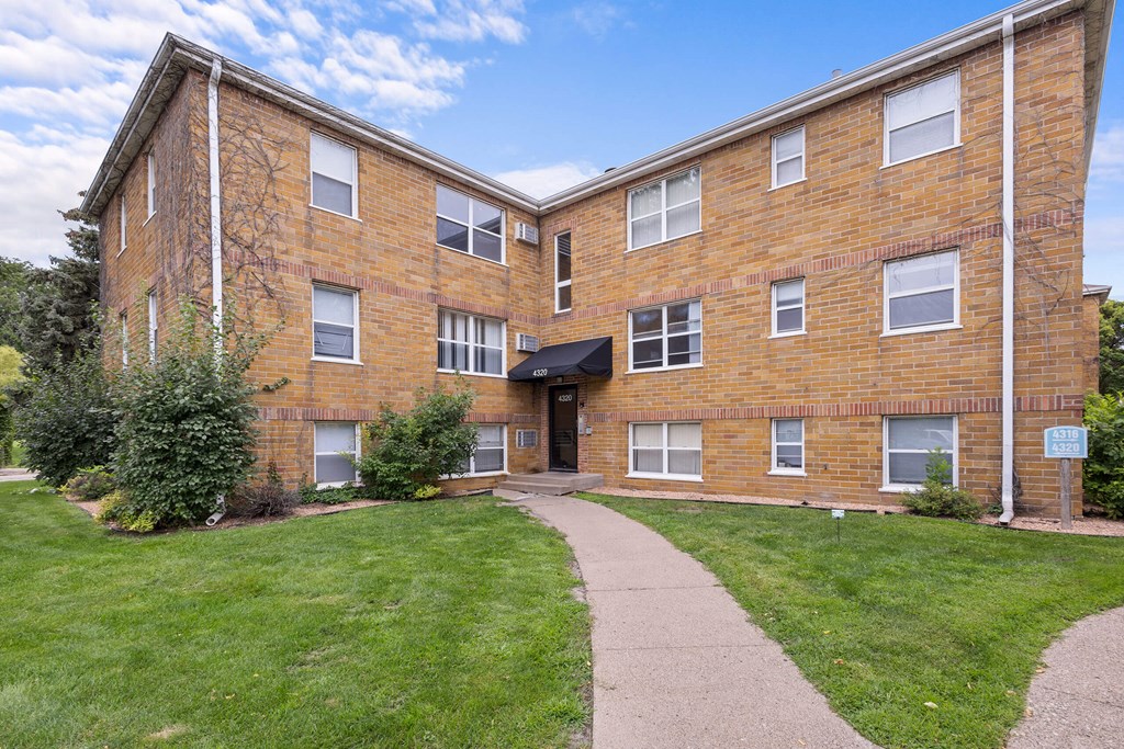 A brick building with a walkway in front.