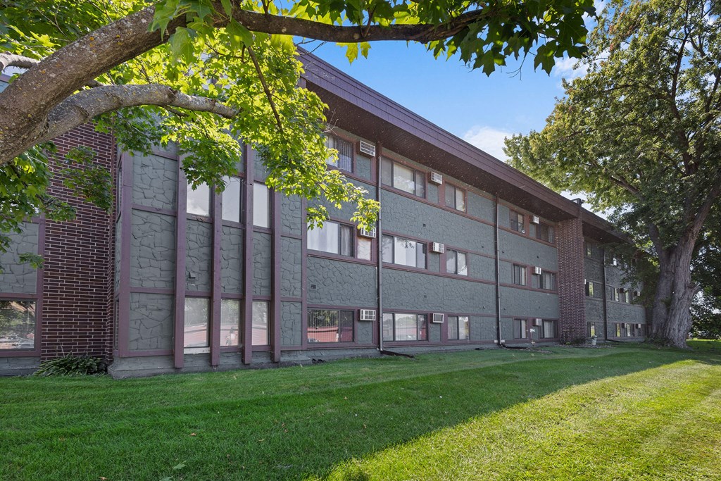 A large building with a grassy area in front of it.