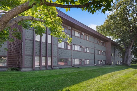 A large building with a grassy area in front of it.