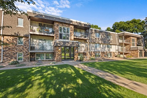 exterior view of the apartments with grass and trees