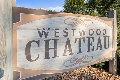 A wooden sign that says Westwood Chateau.