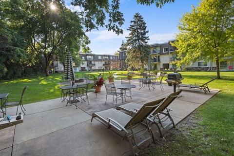 A sunny day at the park with tables and chairs set up for outdoor dining.
