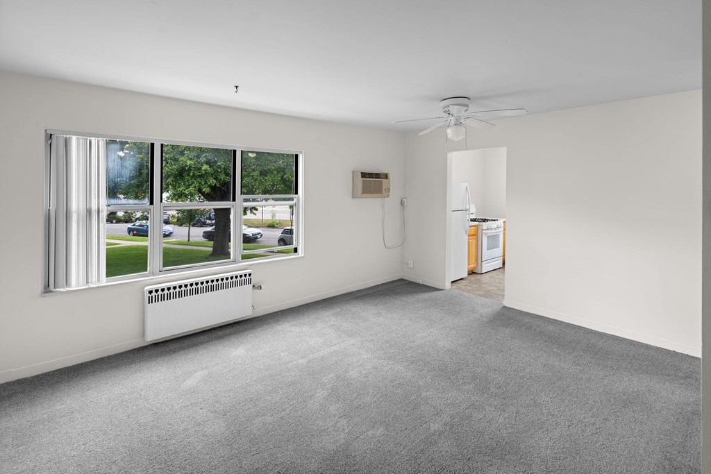 an empty living room with a large window