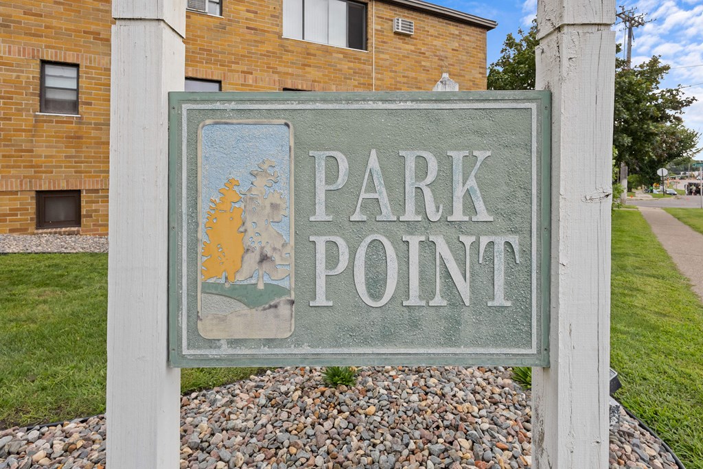 A sign that says Park Point stands in front of a building.