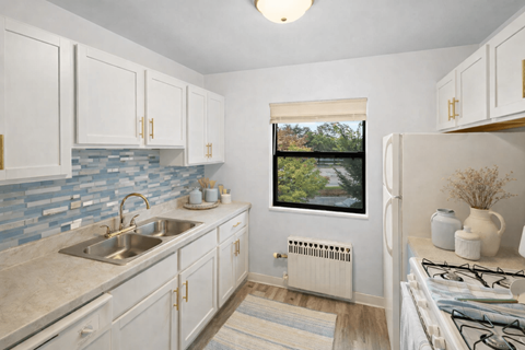 A kitchen with a window overlooking a bridge.