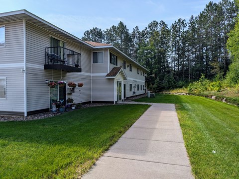 A residential area with a house and a walkway.