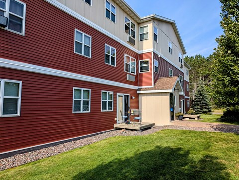 A red building with a white garage door and windows.