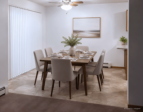 A dining room with a table set for six people.