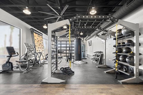 A gym with a variety of equipment including weights and machines.
