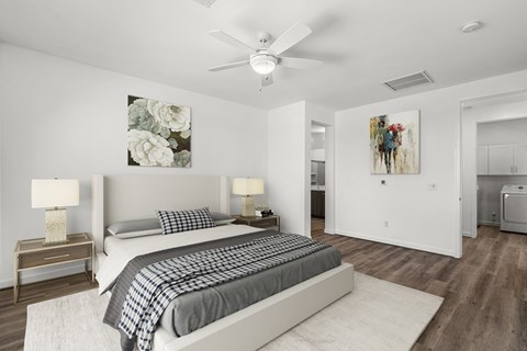 A bedroom with two beds and a ceiling fan.