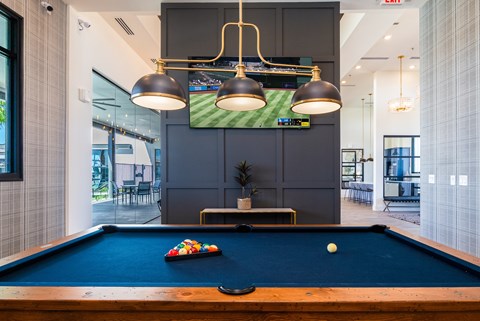 A pool table with a ball in the middle of it.