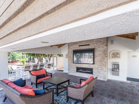 a living room with a fireplace and a table and chairs