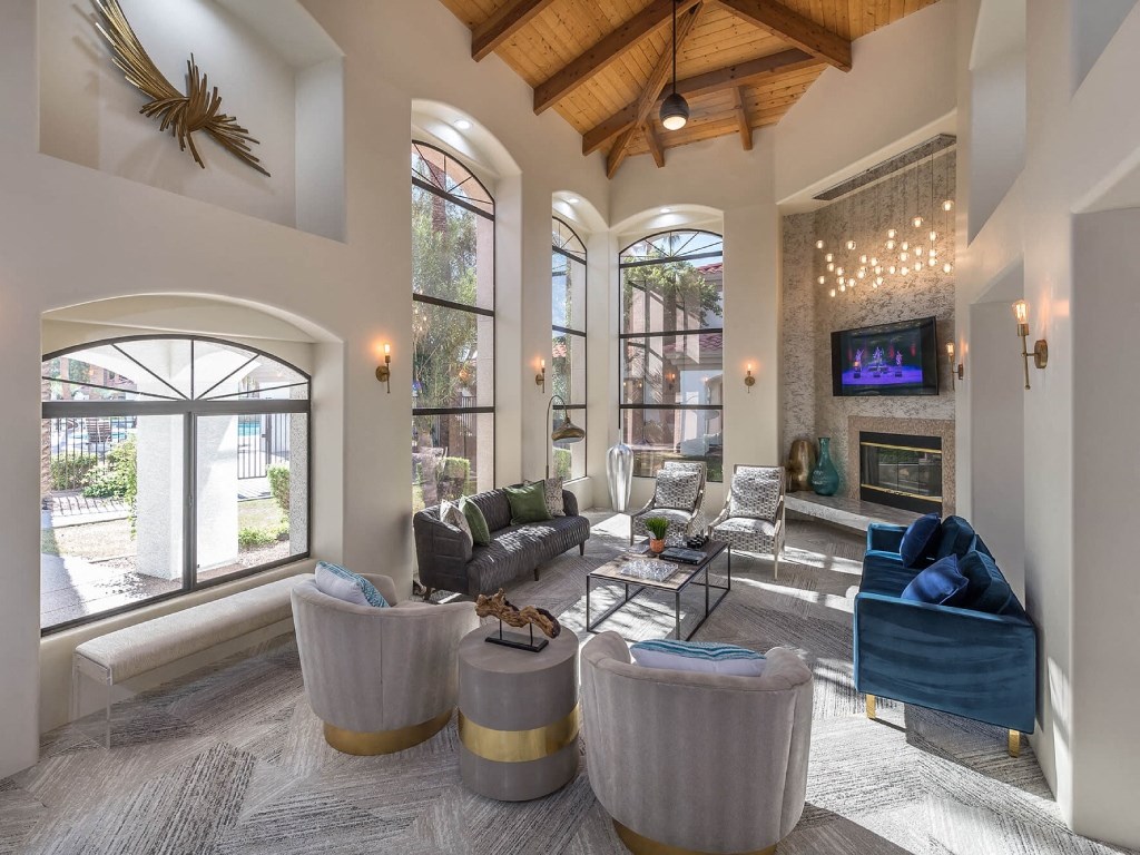 a living room with couches and chairs and a fireplace