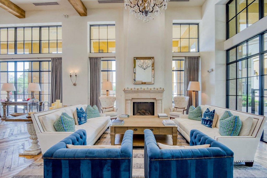 a living room with blue and white furniture and a fireplace