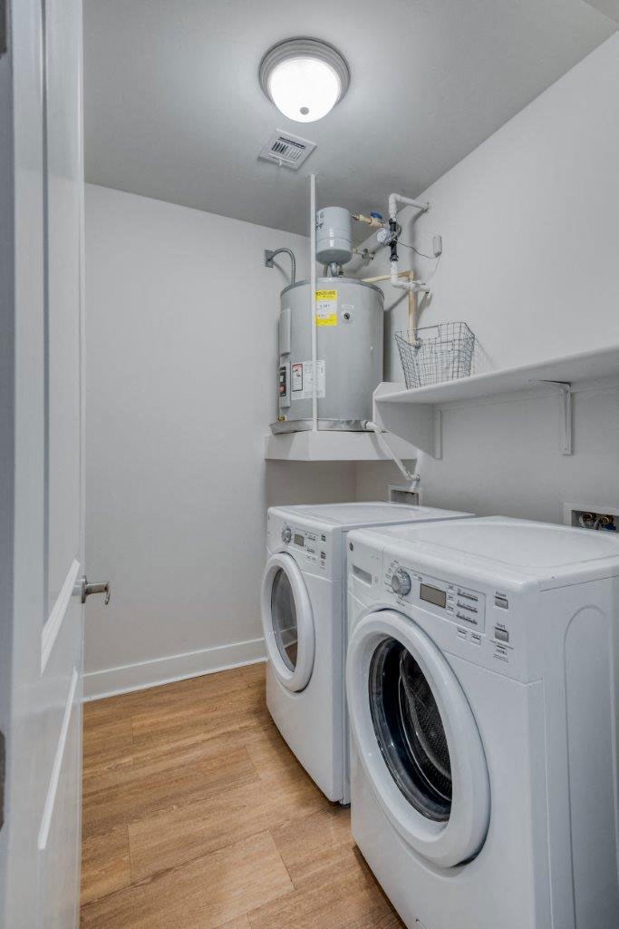 a white laundry room with a washing machine and a dryer