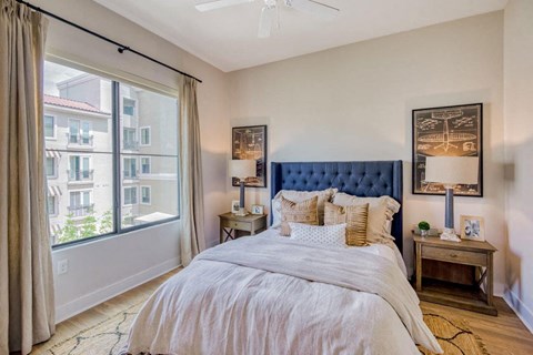 a bedroom with a bed and a large window