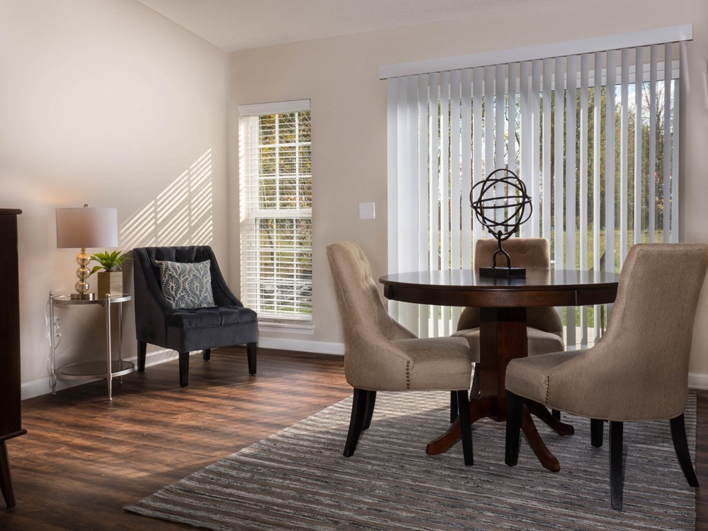 a living room with a table and chairs