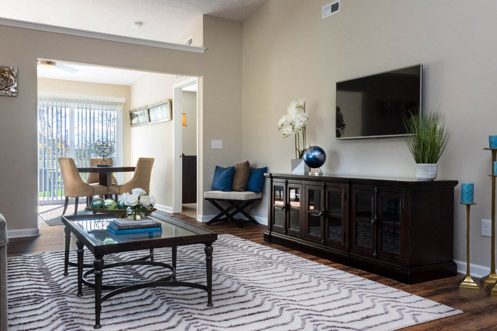 a living room with a coffee table and a television