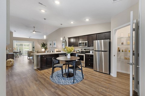 a kitchen with stainless steel appliances and a table