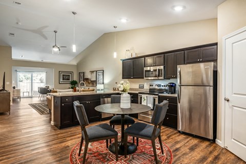 a kitchen and dining area with stainless steel appliances and a table