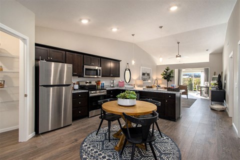 a kitchen with stainless steel appliances and a round table