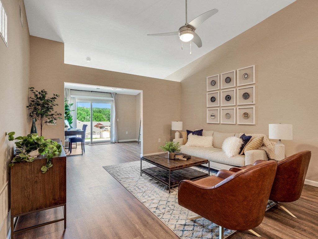 a living room with furniture and a ceiling fan