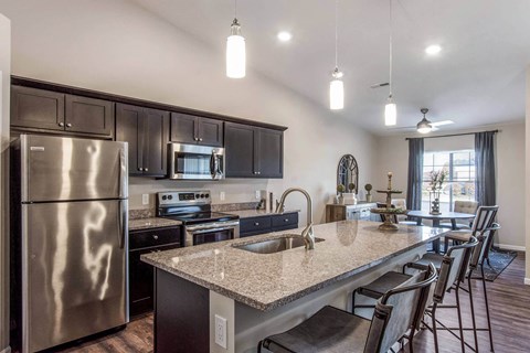 a kitchen with stainless steel appliances and granite counter tops