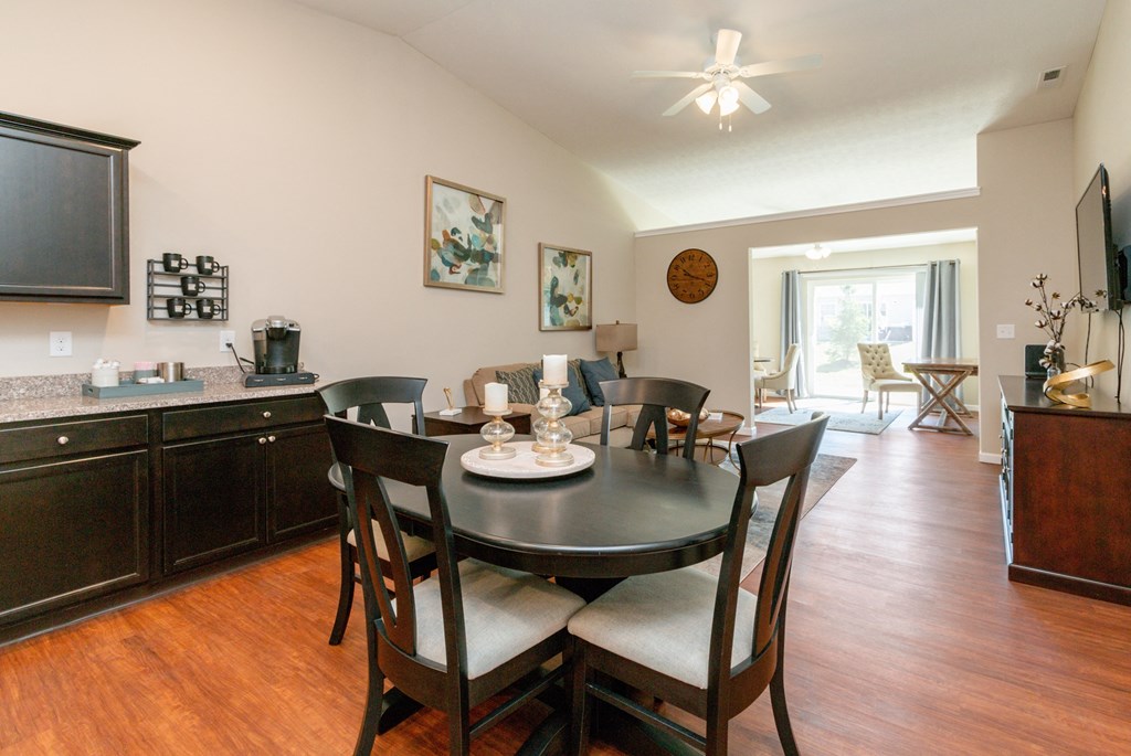 a dining area with a table and chairs and a television