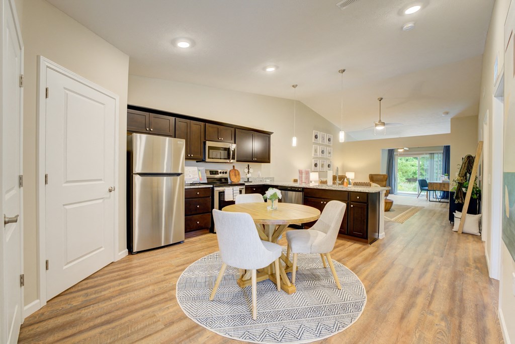 a kitchen and dining room with a table and chairs