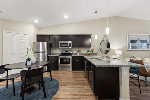 an open kitchen and dining area with a table and chairs