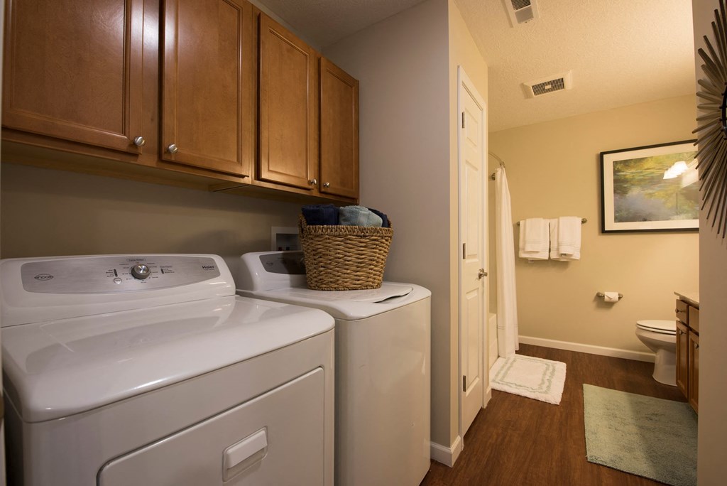 a small bathroom with a washer and dryer in it and a laundry room