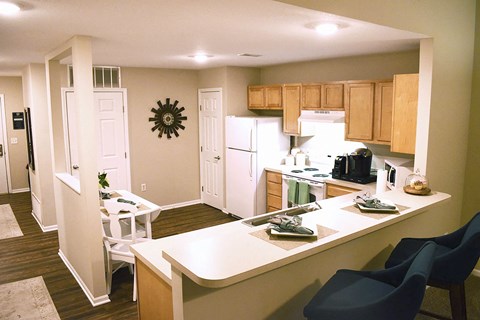 a kitchen and dining room with a table and chairs