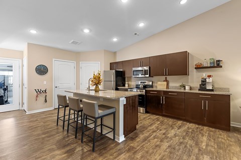 A kitchen with brown cabinets and a white island.