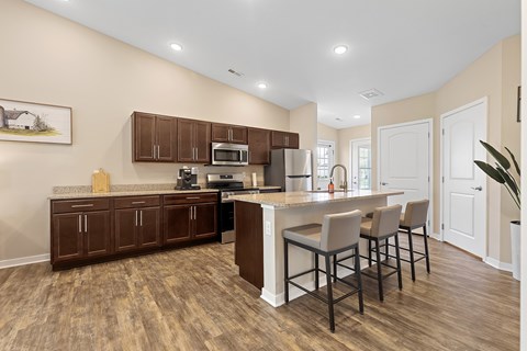 A kitchen with brown cabinets and a white island.