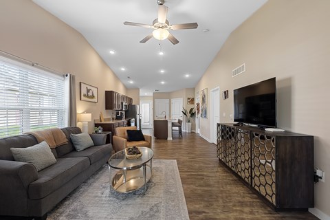 A living room with a grey couch and a coffee table.