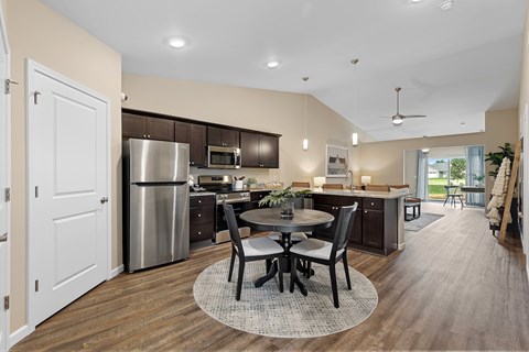 A modern kitchen with a dining table set for four.