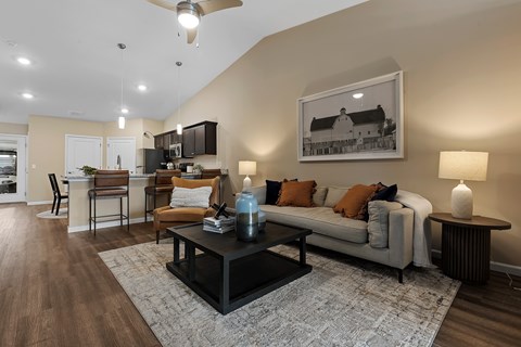 A living room with a couch, coffee table, and a painting on the wall.
