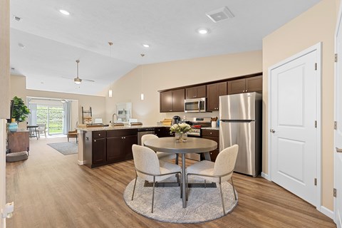 A modern kitchen with a dining table and chairs.