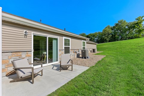A house with a patio and lawn.